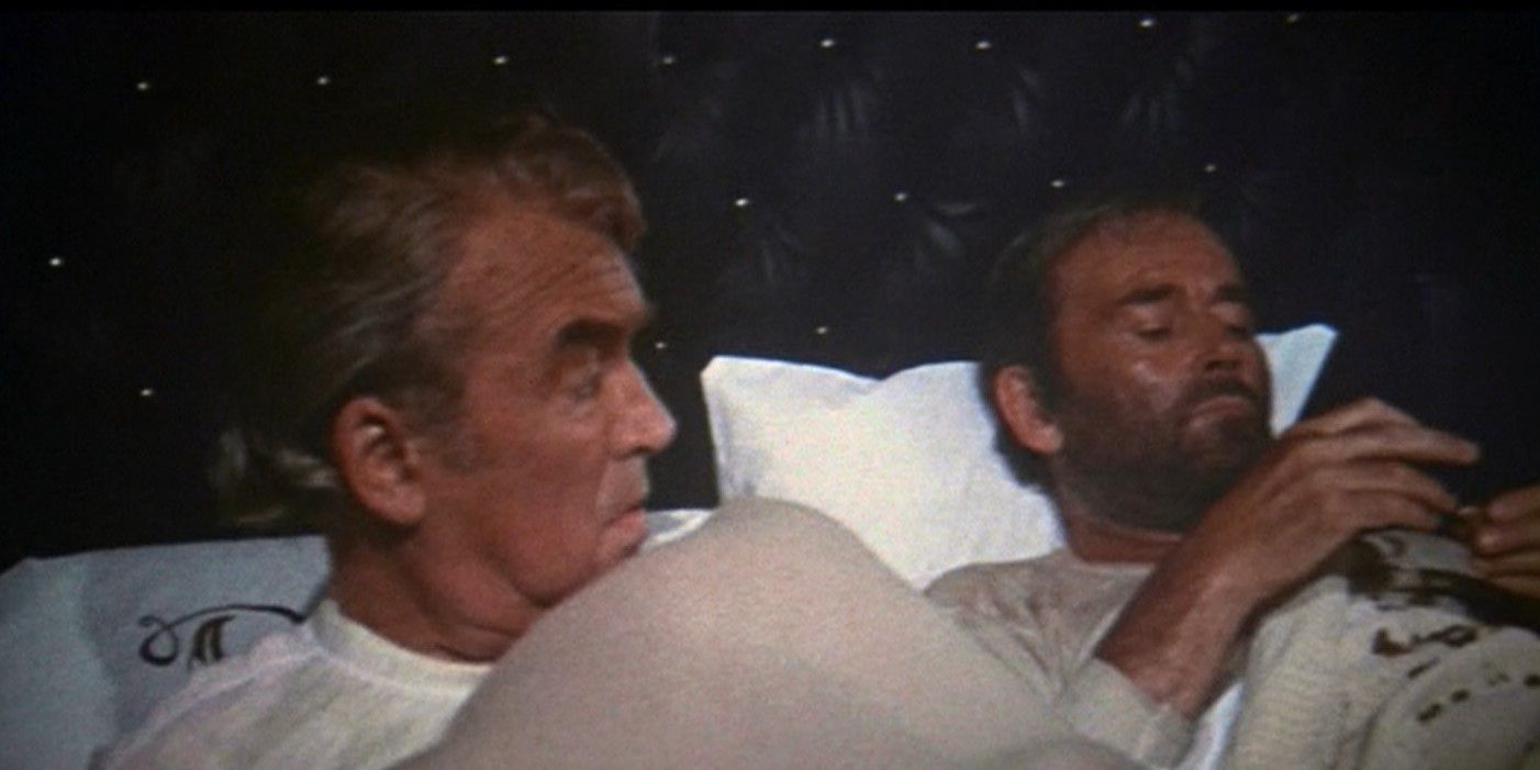 James Stewart as John O'Hanlan and Henry Fonda as Harley Sullivan lying in a bed in The Cheyenne Social Club
