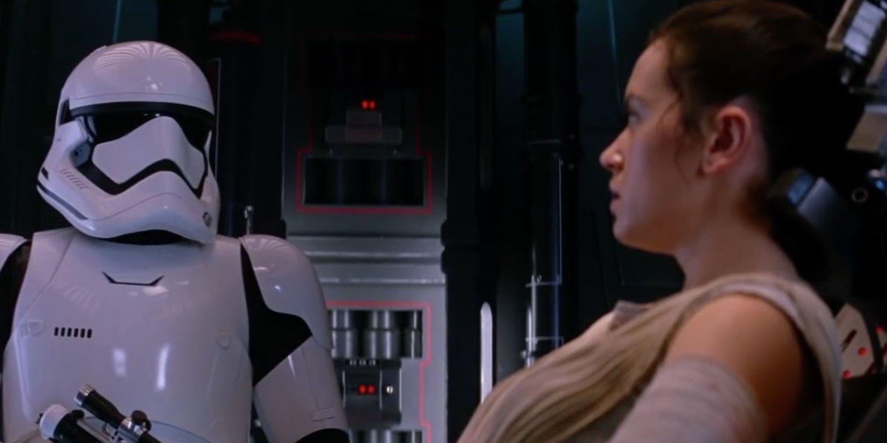 Rey (Daisy Ridley) trapped and guarded by a stormtrooper in Star Wars: The Force Awakens.