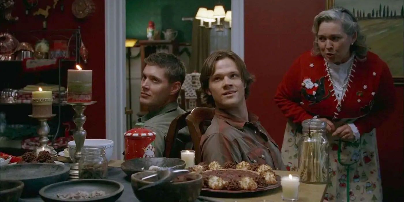 Sam and Dean Winchester are tied up, sitting back to back on a chair while a pagan god prepares them for sacrifice.