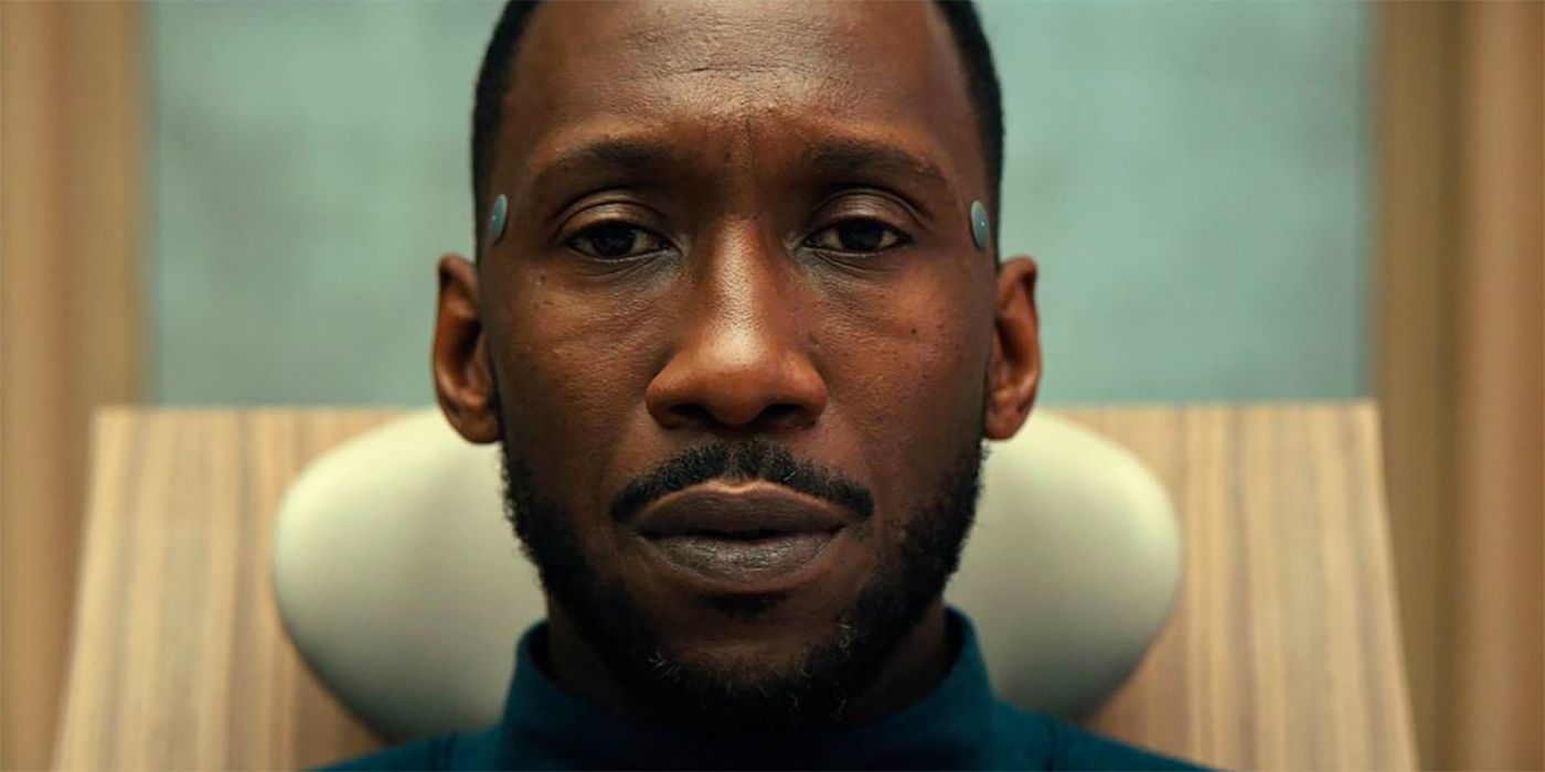 Mahershala Ali as Cameron looking pensive with electrodes in his temples in Swan Song