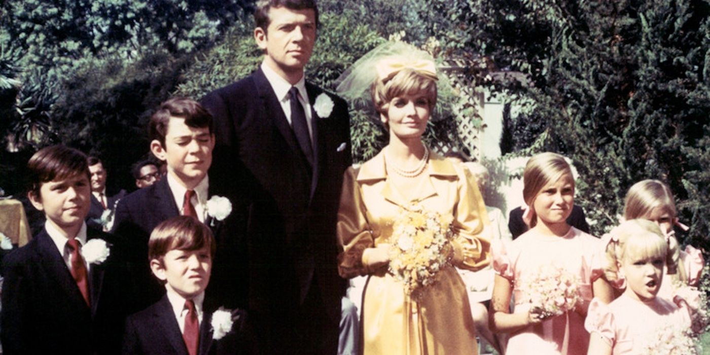 The cast of the Brady Bunch assemble for a wedding photo in the first episode 'The Honeymoon'