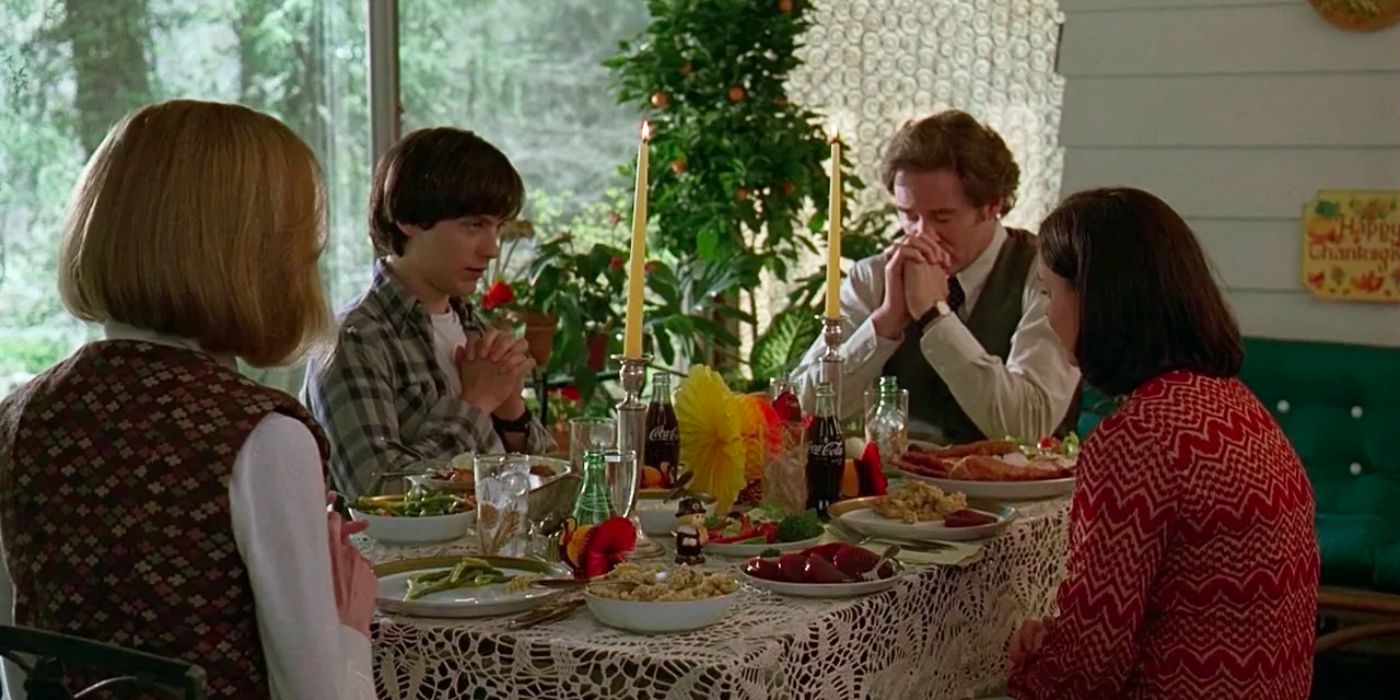 Tobey Maguire and Kevin Kline with costars as a family saying grace before a meal in The Ice Storm.