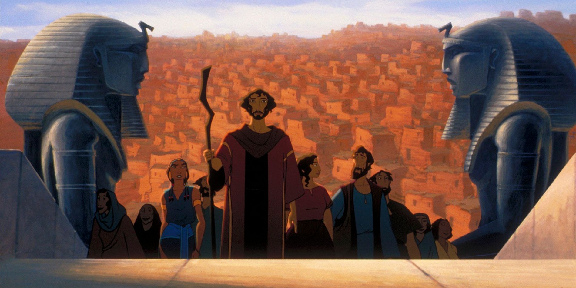 A wide shot of Moses leading his family and a larger group up the steps to visit the Pharaoh in The Prince of Egypt