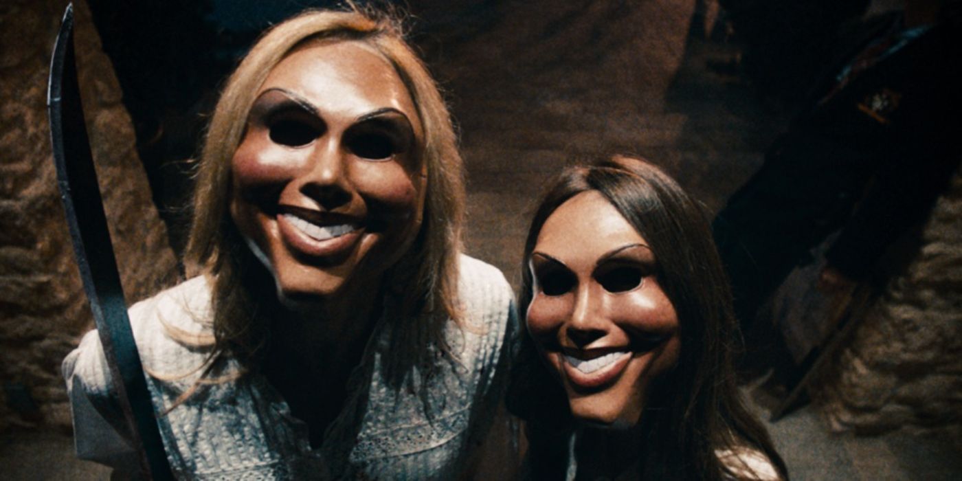 Two people wearing purge masks in The Purge 