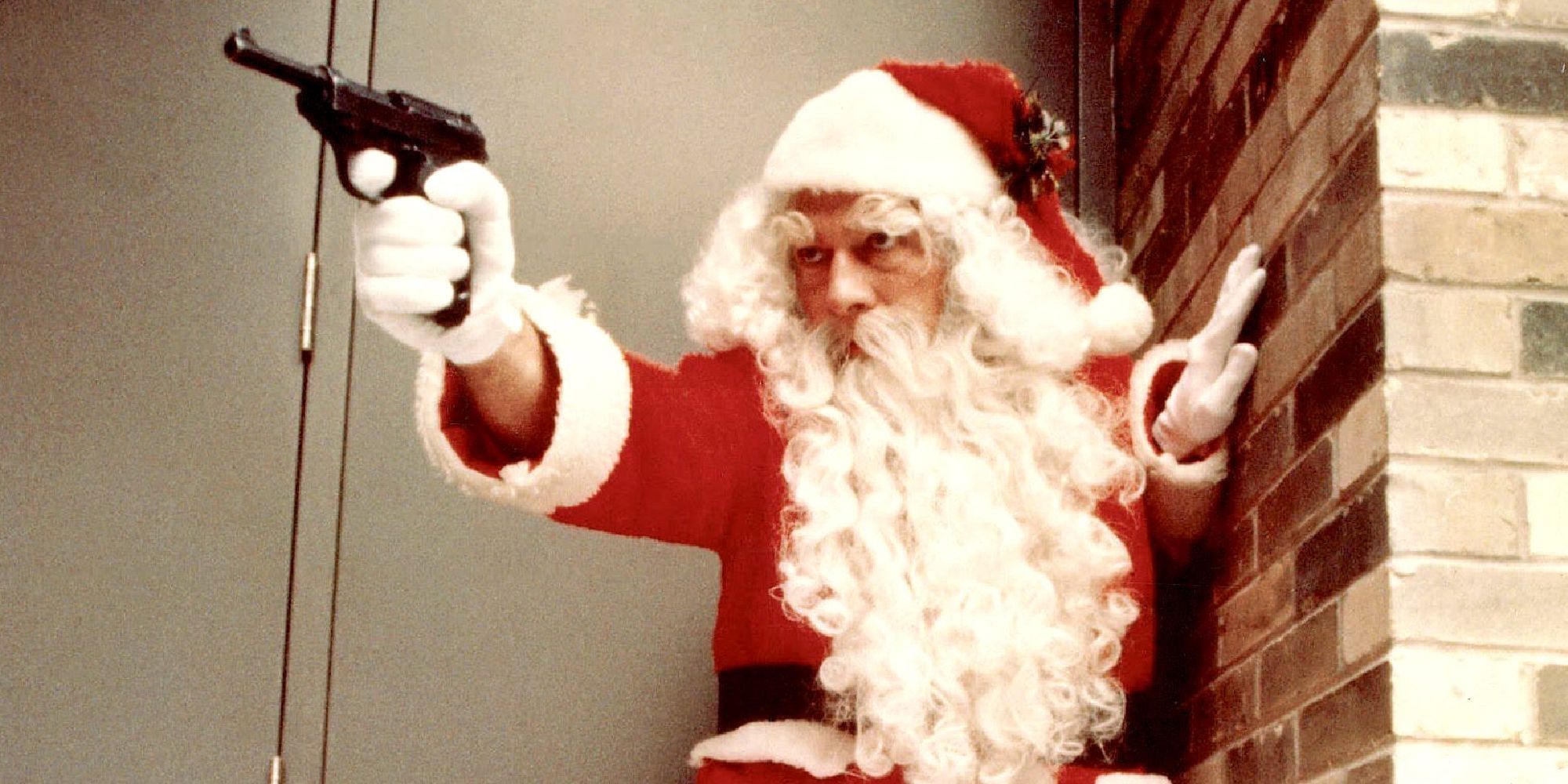 A man dressed as Santa Clause pointing a gun at something off camera in The Silent Partner.