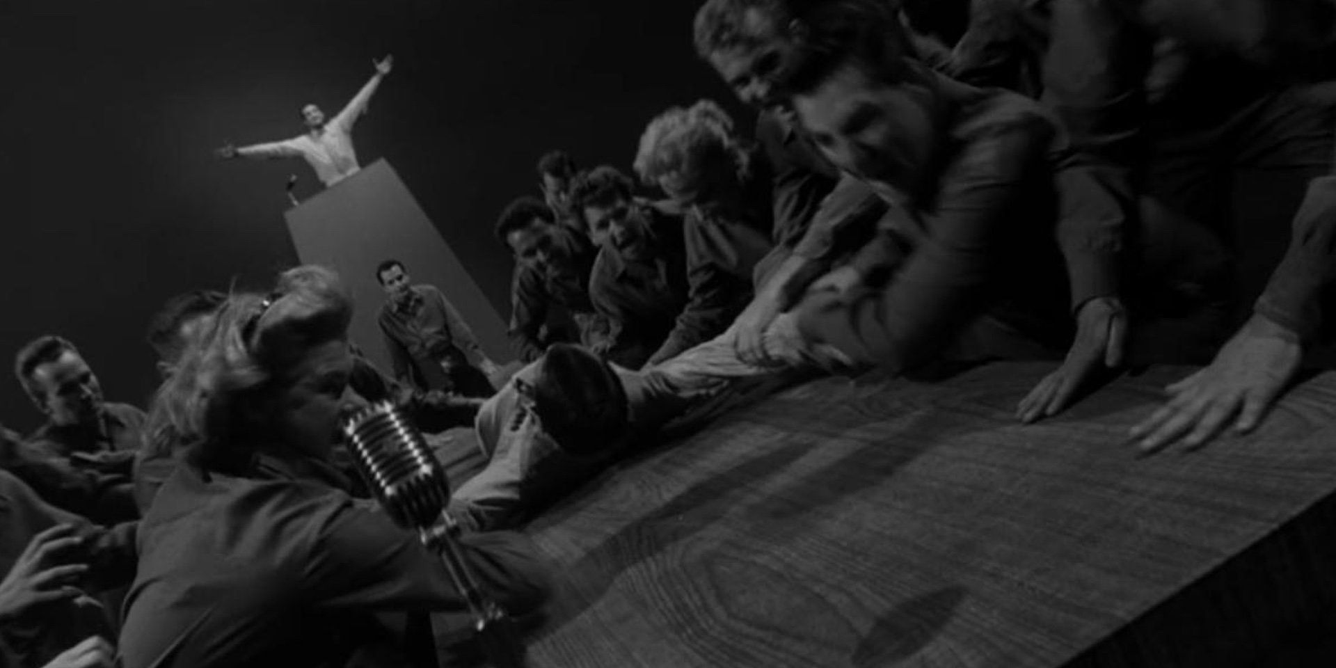 Black and white image of People shouting at a table during a trial in The Twilight Zone