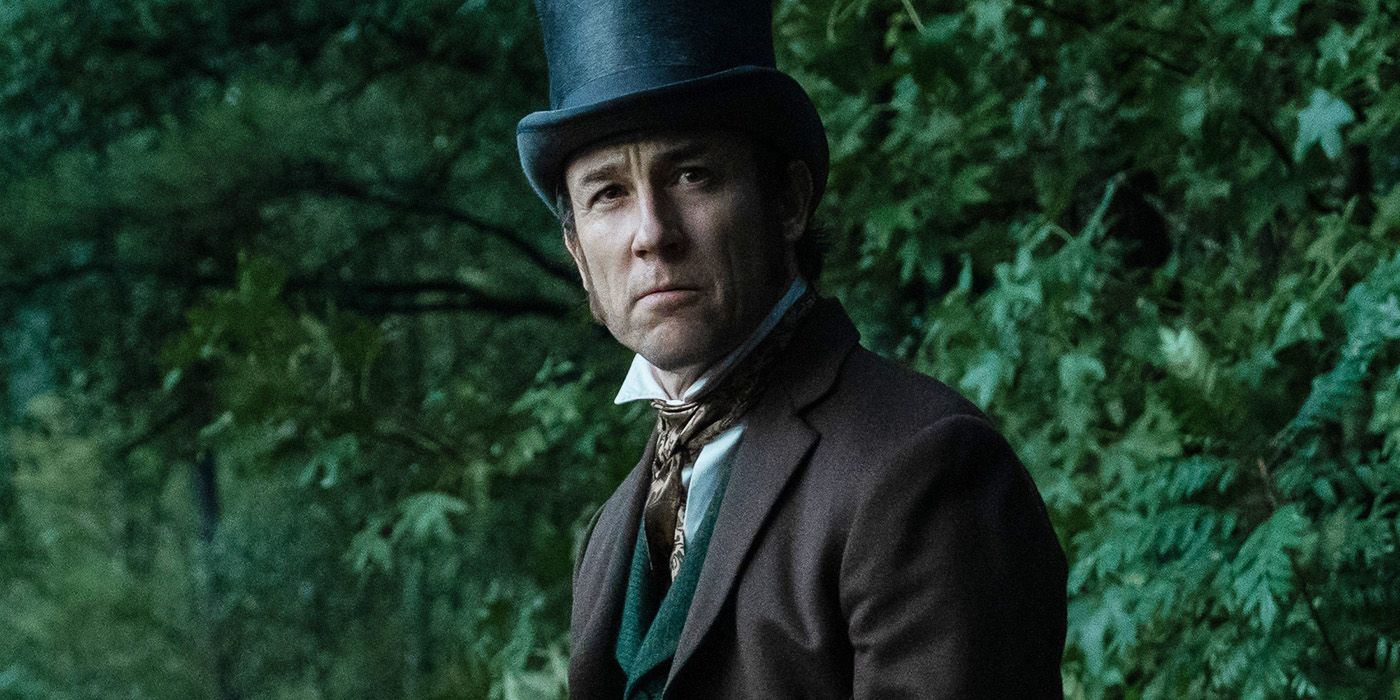 Tobias Menzies wears a top hat in the woods in Manhunt