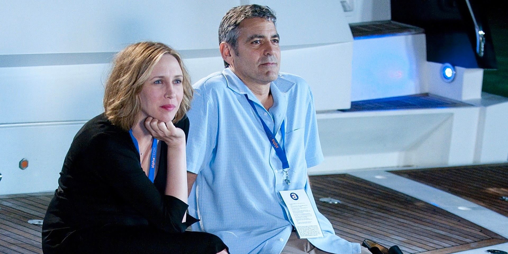 Vera Farmiga and George Clooney as Alex and Ryan sitting together on a boat during a convention.