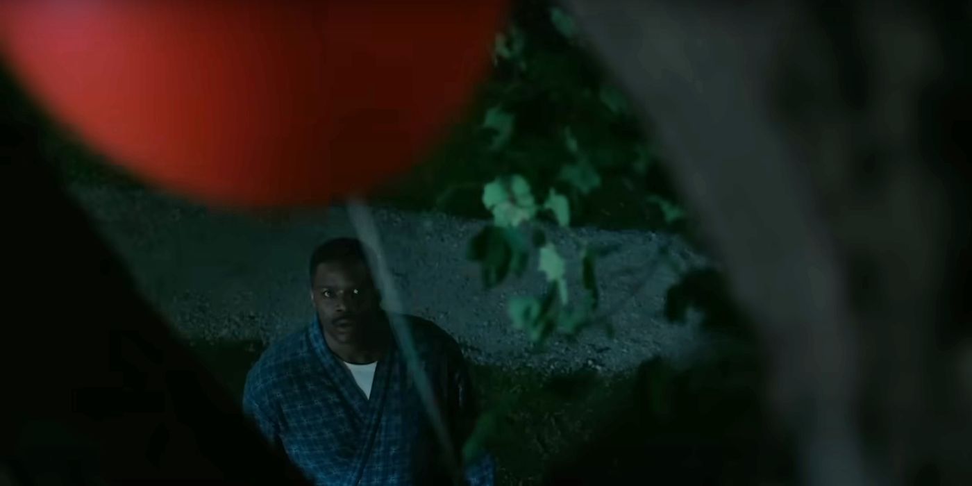 Jovan Adepo staring at a red balloon in a tree in Welcome to Derry