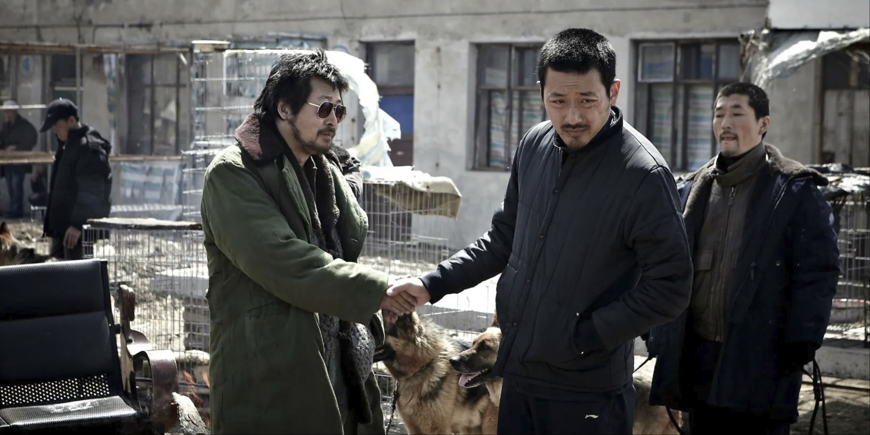 Men shake hands as another looks on in The Yellow Sea