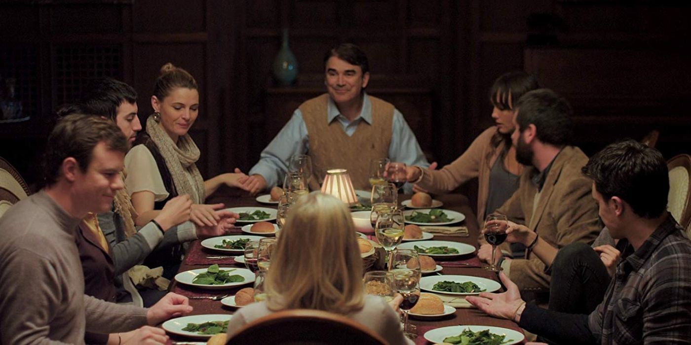 Joe Swanberg as Drake, AJ Bowen as Crispian and Sharni Vinson as Erin having family dinner together in You're Next.