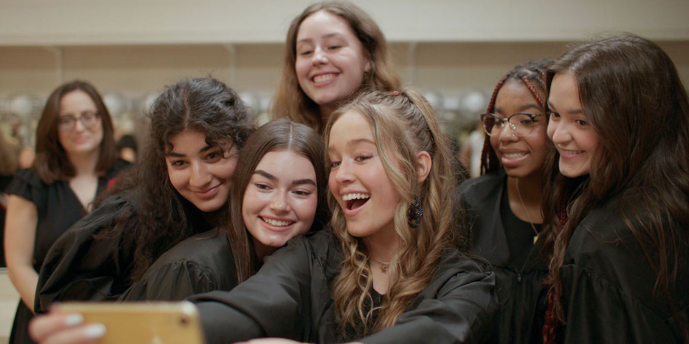 A group of girls pose for a selfie in a still from the documentary Girls State. 