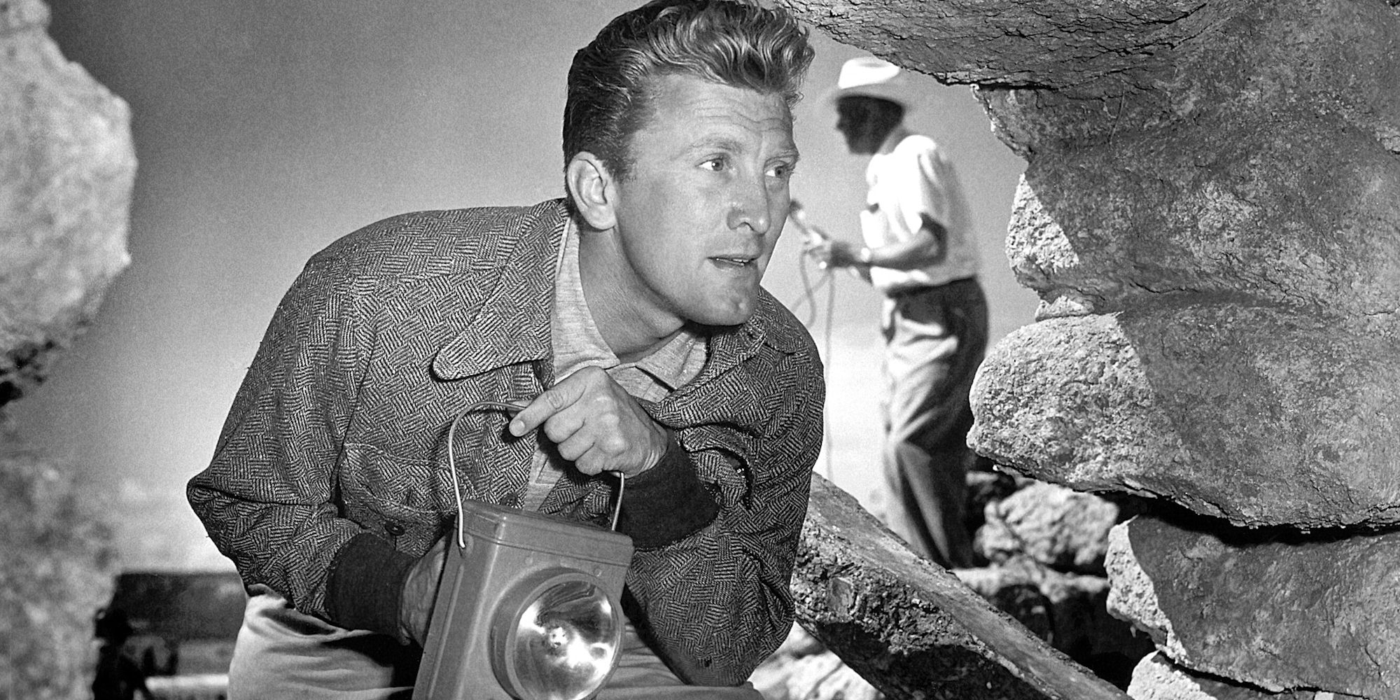 Kirk Douglas searching a cave in Ace in the Hole 