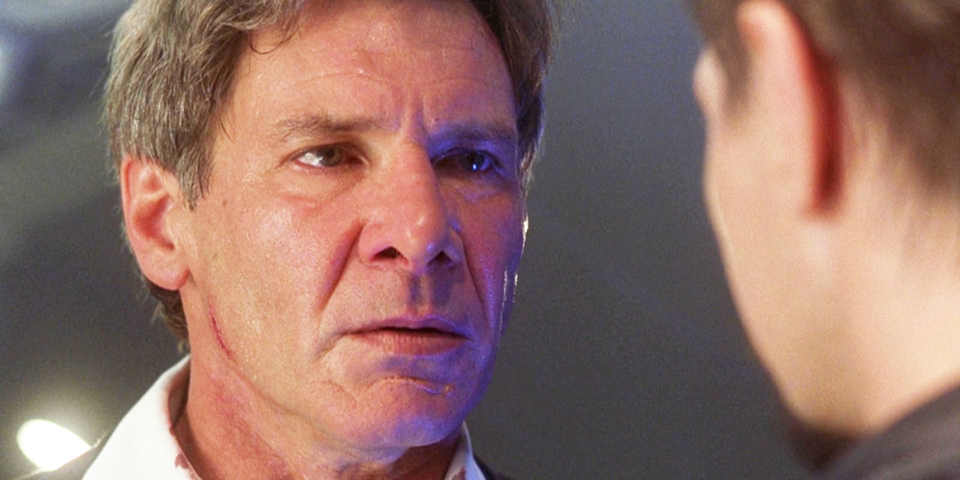 A close up of Harrison Ford as President James Marshall staring imploringly at an offscreen Gary Oldman in Air Force One