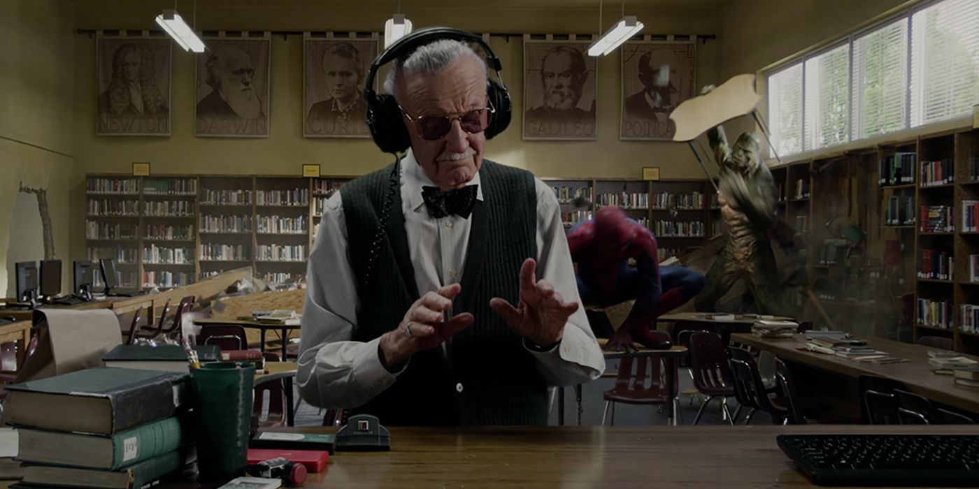 Stan Lee the librarian listens to music through noise-cancelling headphones as Spider-Man fights Lizard in the background