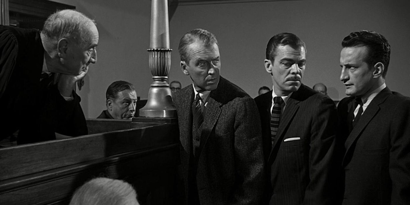 Paul Biegler, played by Jimmy Stewart, looking back at two prosecuting attorneys, played by Brooks West and George C. Scott, as they all stand at the judge&rsquo;s bench in Anatomy of a Murder