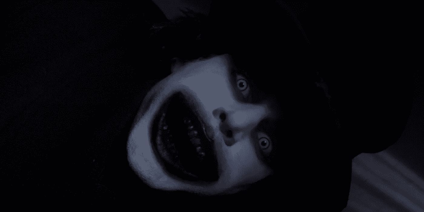 The Babadook with its mouth open looking directly at the camera in the film The Babadook.