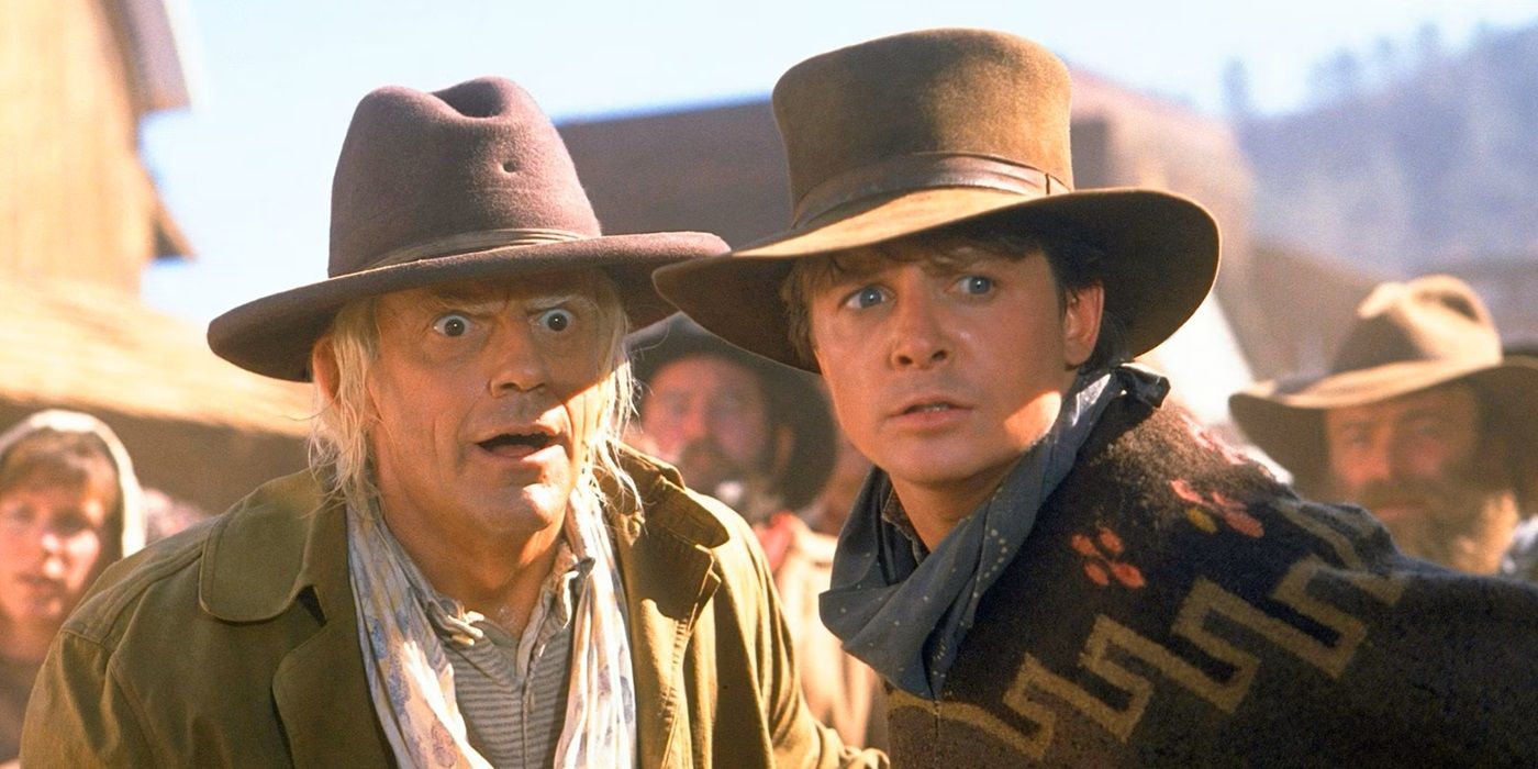 Michael J. Fox as Marty McFly and Christopher Lloyd as Doc Brown looking at a person offscreen in Back to the Future 3