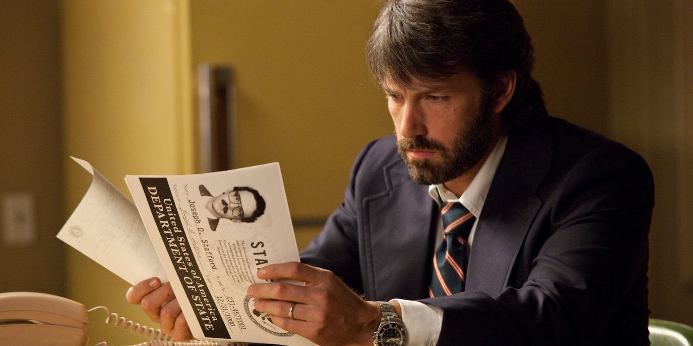Tony reviewing some papers in Argo (2012)