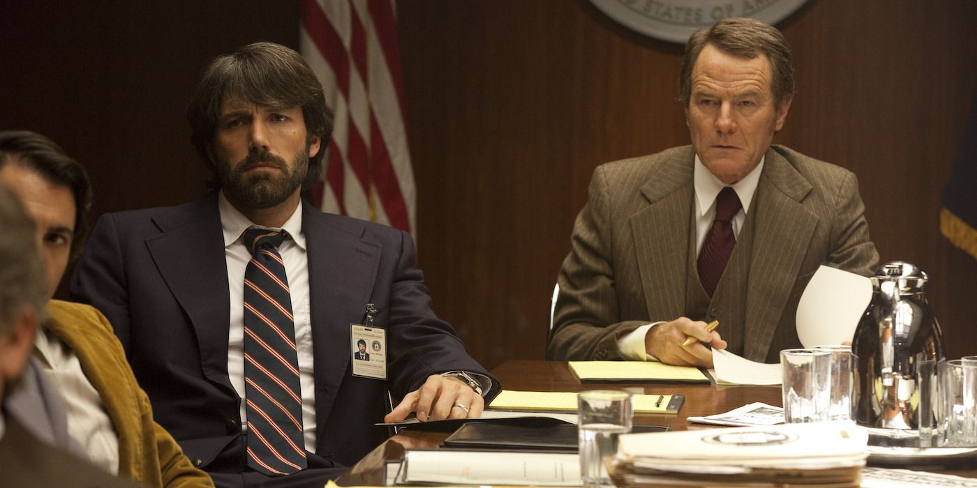 Tony (Ben Affleck) and Jack (Bryan Cranston) sitting at a briefing in Argo (2012)
