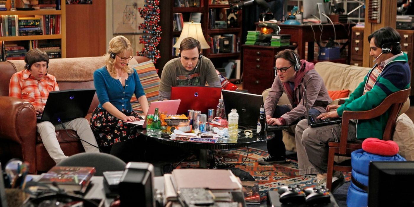 The Big Bang Theory cast sitting in the living room on computers