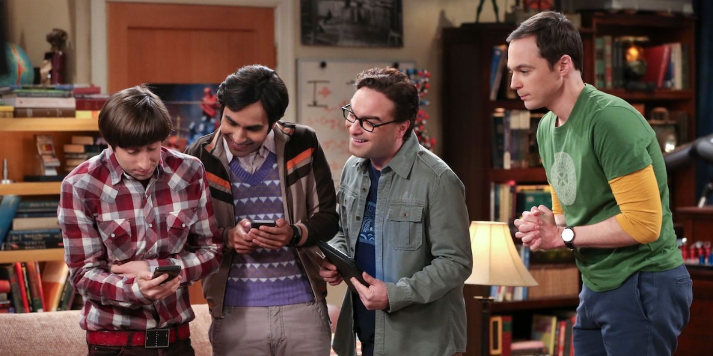 Howard, Leonard, Raj, and Sheldon look at a phone