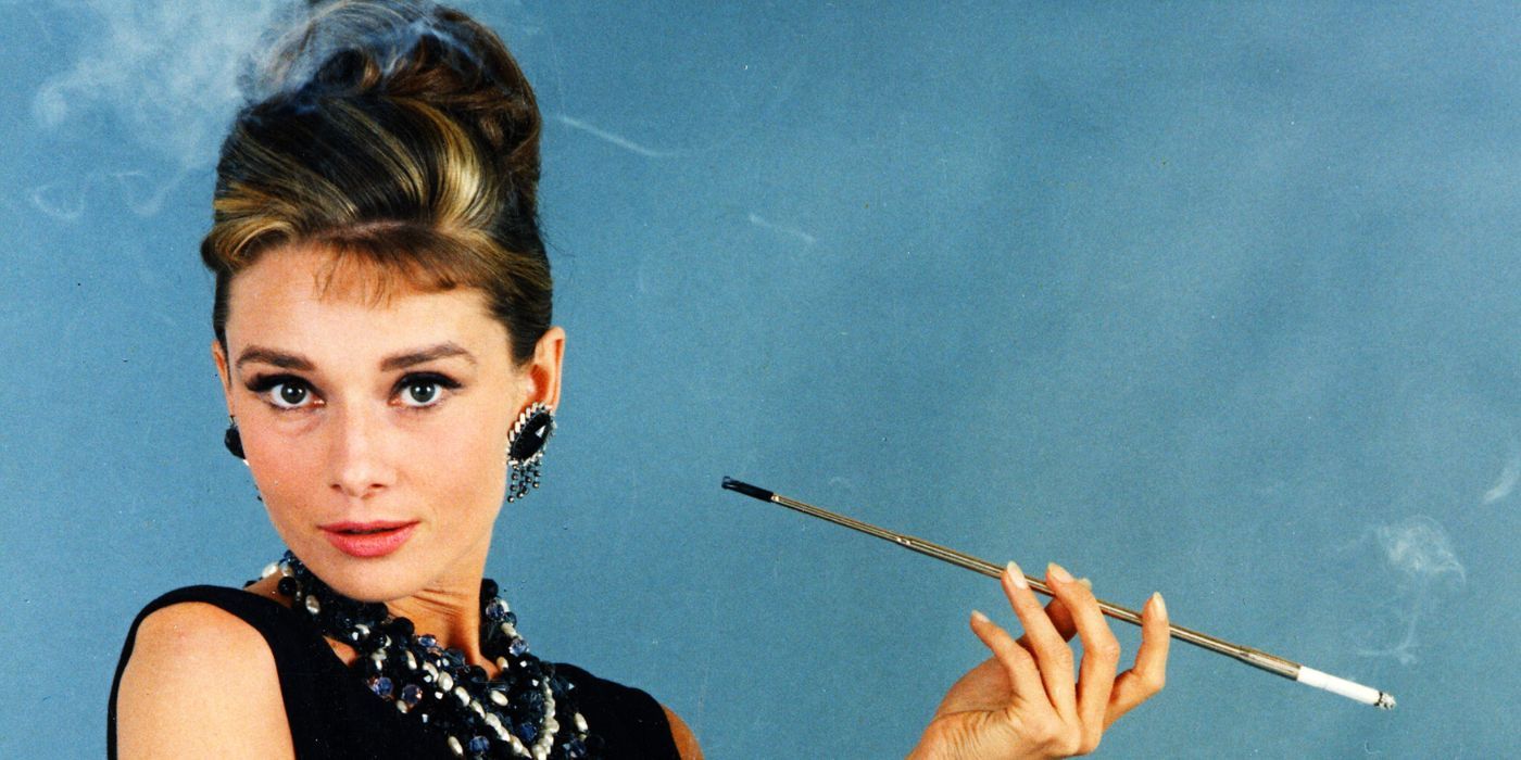 Audrey Hepburn as Holly Golightly, holding a long cigarette holder in Breakfast at Tiffanys