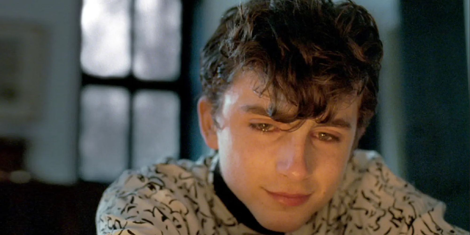 Elio, played by Timothee Chalamet, cries by the fireside in Call Me By Your Name