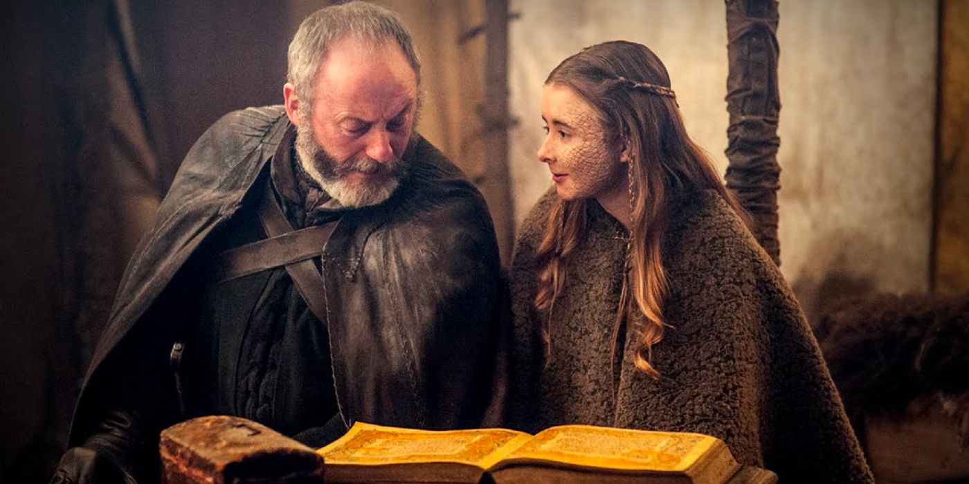 Davos Seaworth looks at a book while Shireen Baratheon teaches him how to read in Game of Thrones