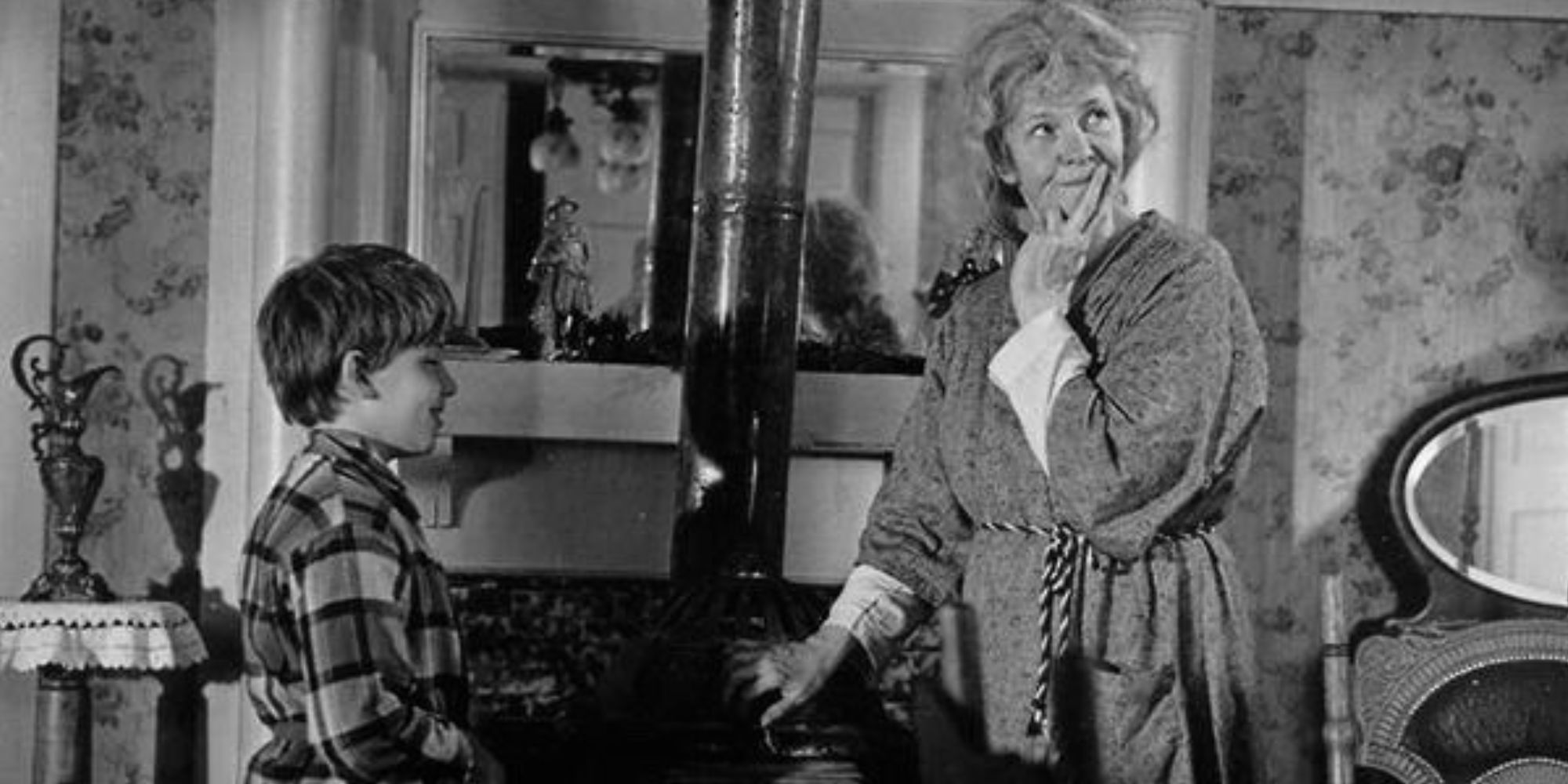 Donnie Melvin and Geraldine Page standing in front of a potbelly stove in Trilogy (1969)