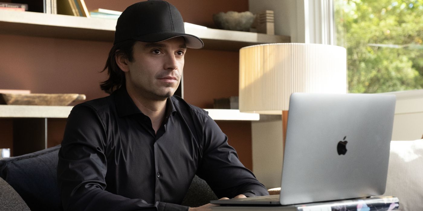 Vlad Tenev, portrayed by Sebastian Stan, wearing all black and sitting in front of a laptop in Dumb Money