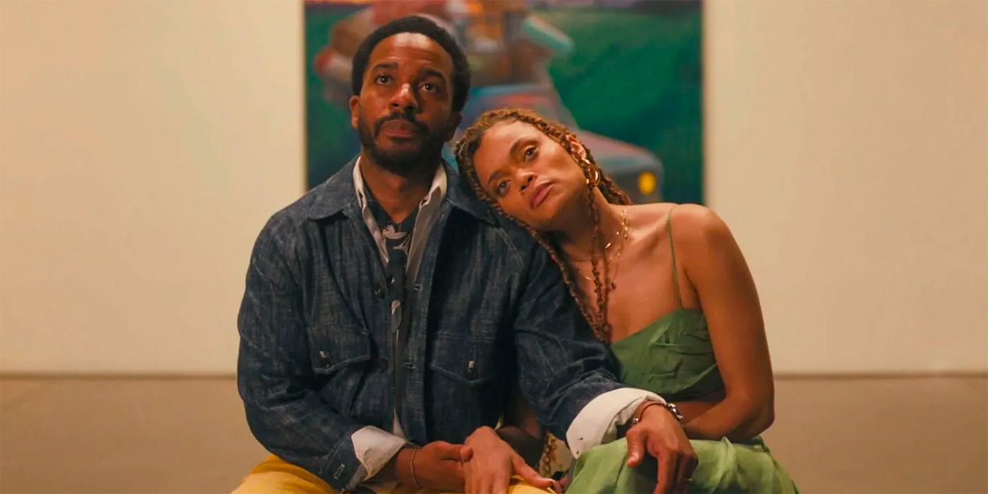 Andre Holland and Andra Day sit next to each other while looking at a painting in an art gallery