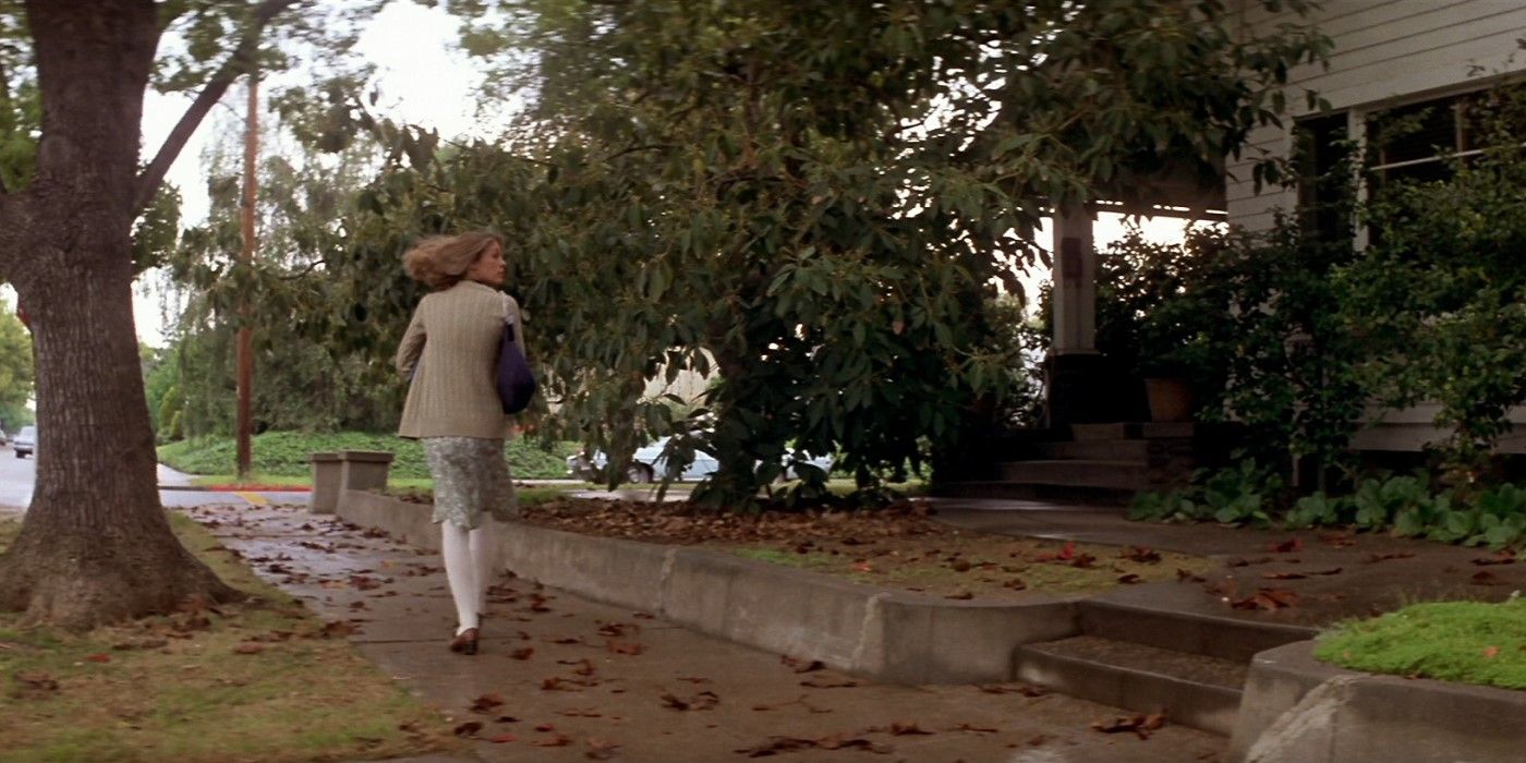 Laurie Strode (Jamie Lee Curtis) walking down a sidewalk in &lsquo;Halloween&rsquo; (1978)