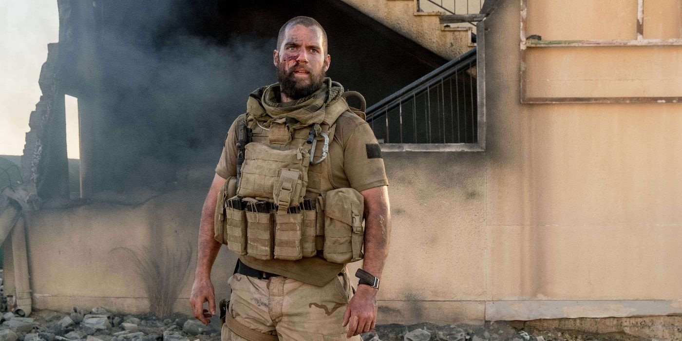 Henry Cavill as Captain Syverson, standing bloodied in front of a smoking building in Sand Castle