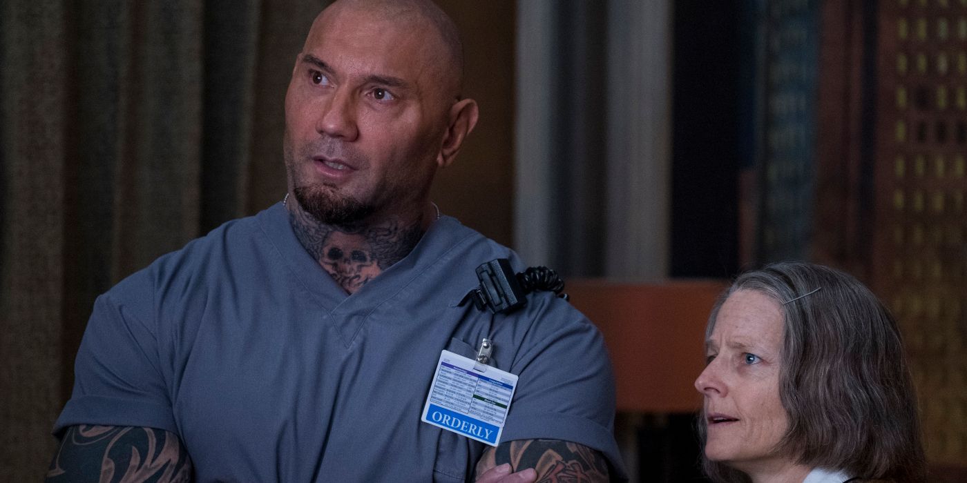 Jodie Foster and Dave Bautista staring offscreen in Hotel Artemis