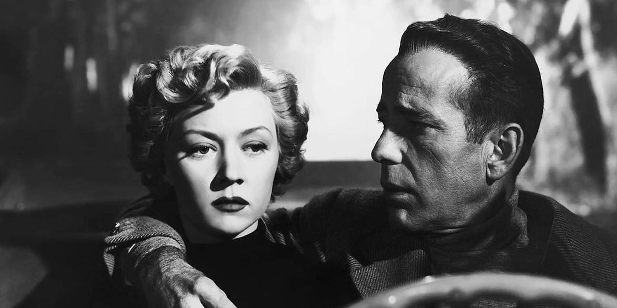 Humphrey Bogart holding Gloria Grahame in the car in In a Lonely Place