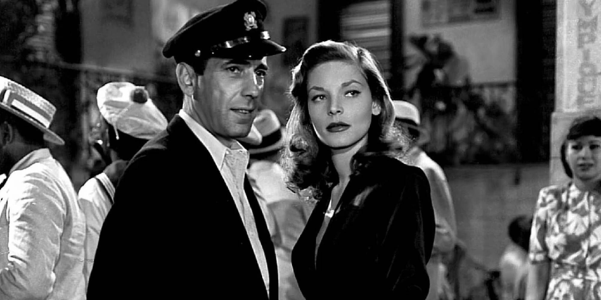 Humphrey Bogart and Lauren Bacall looking at something or someone off-camera in To Have or Have Not.