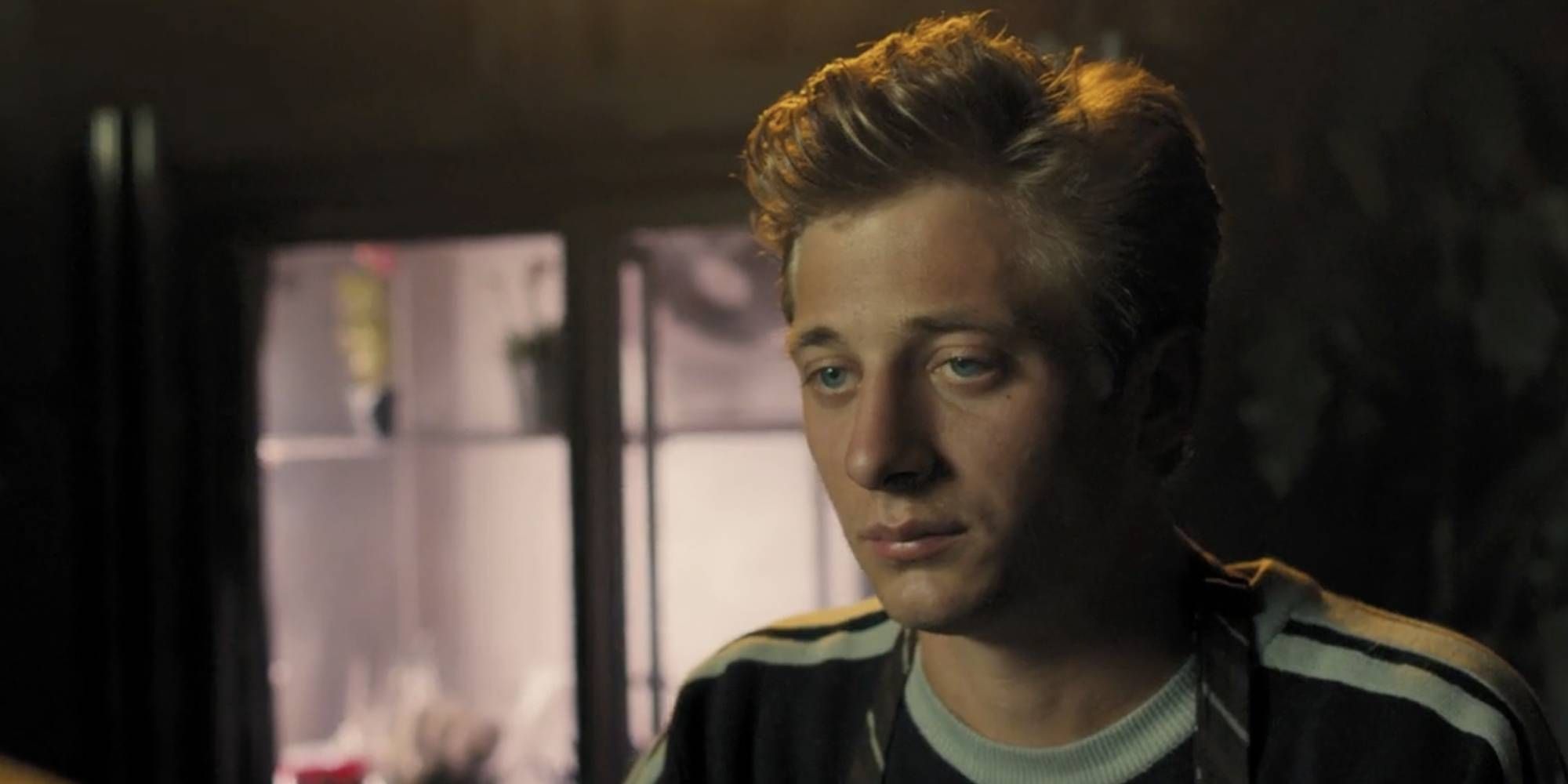 Close up shot of Jeremy Allen White with a sad expression in Rob the Mob