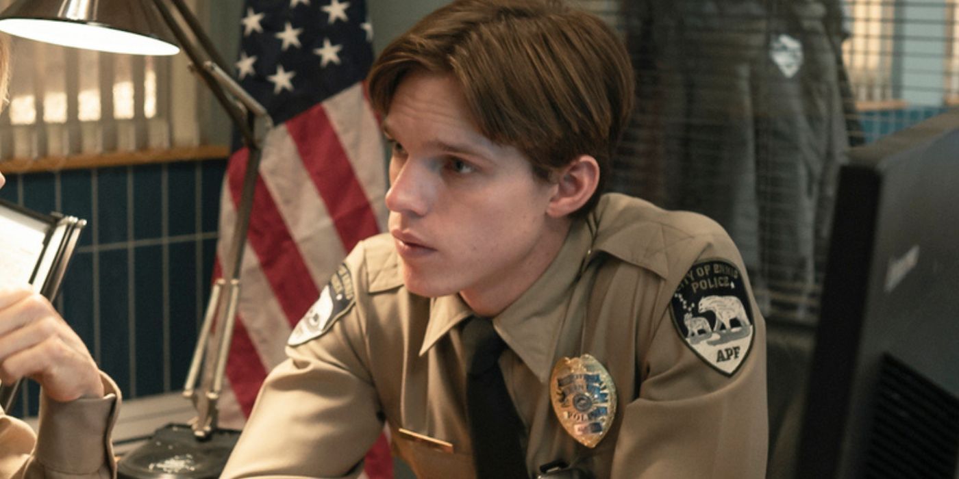Finn Bennett as Peter Prior at a police desk in True Detective: Night Country 