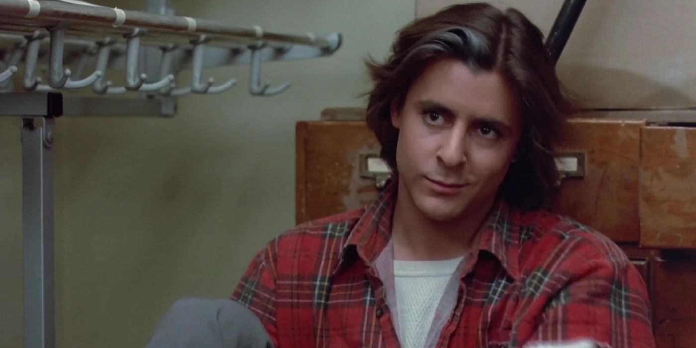 John Bender (Judd Nelson) sitting against a library catalogue in The Breakfast Club
