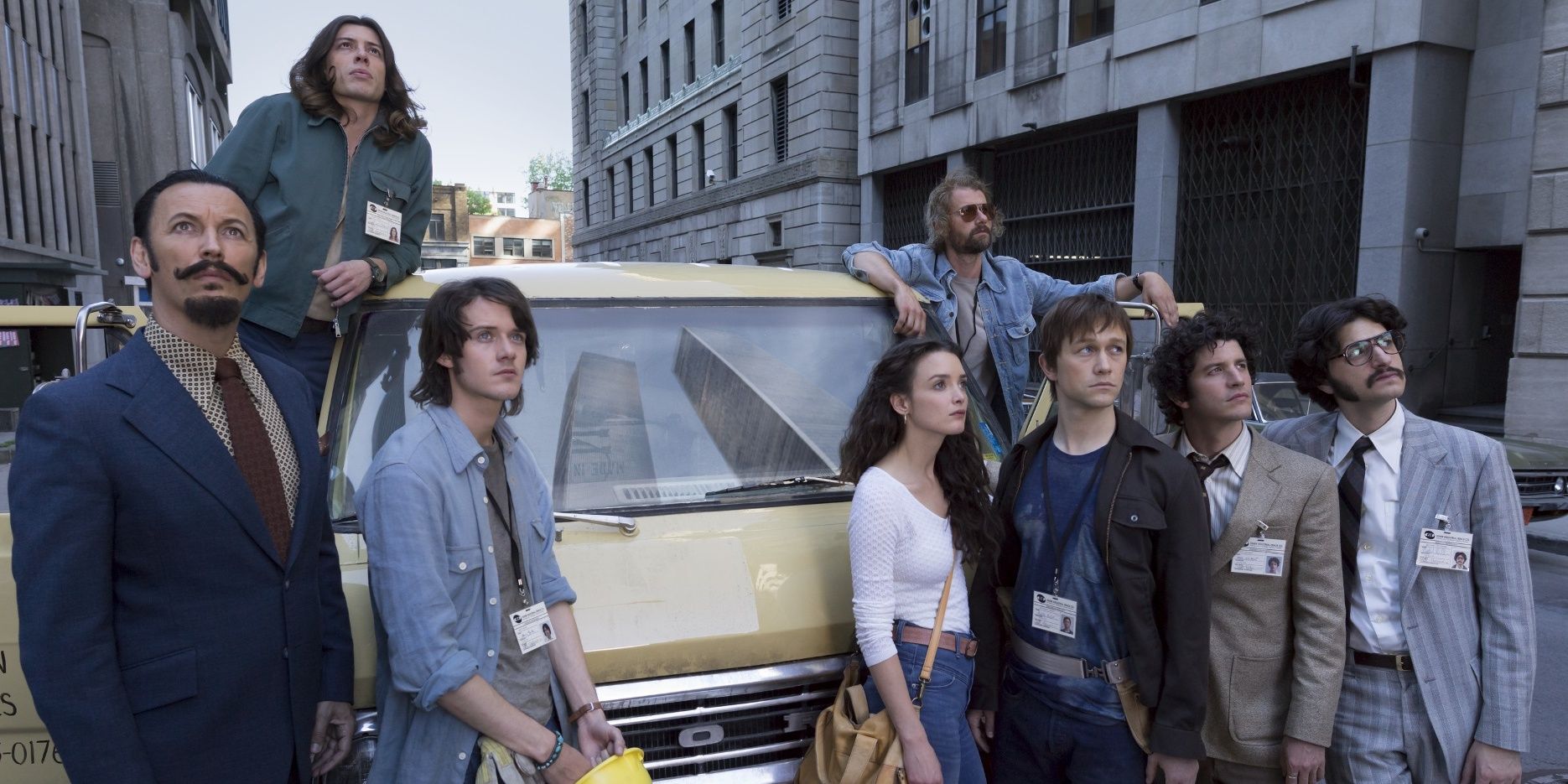 Joseph Gordon-Levitt as Philippe and his co-stars standing around a car in The Walk