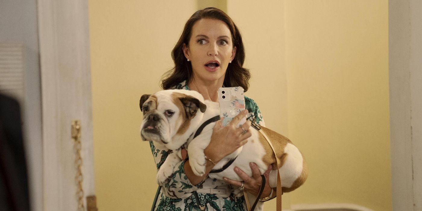 Kristin Davis as Charlotte, holding a bulldog and looking stunned in And Just Like That...