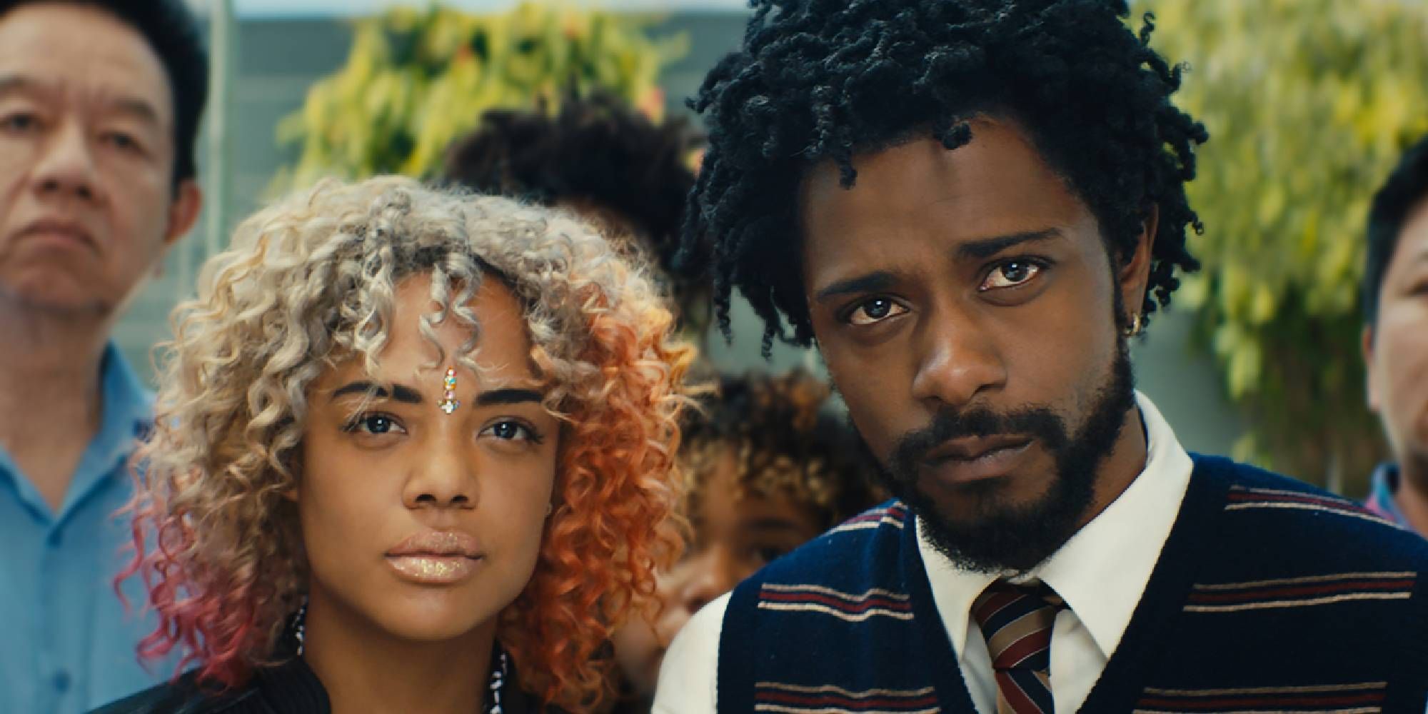 A shot of LaKeith Stanfield and Tessa Thompson as Cassius and Detriot, looking seriously at something offscreen in Sorry to Bother You