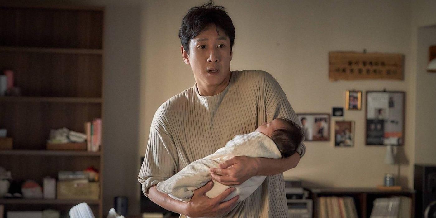 Lee Sun-kyun holding a baby in Sleep 2023