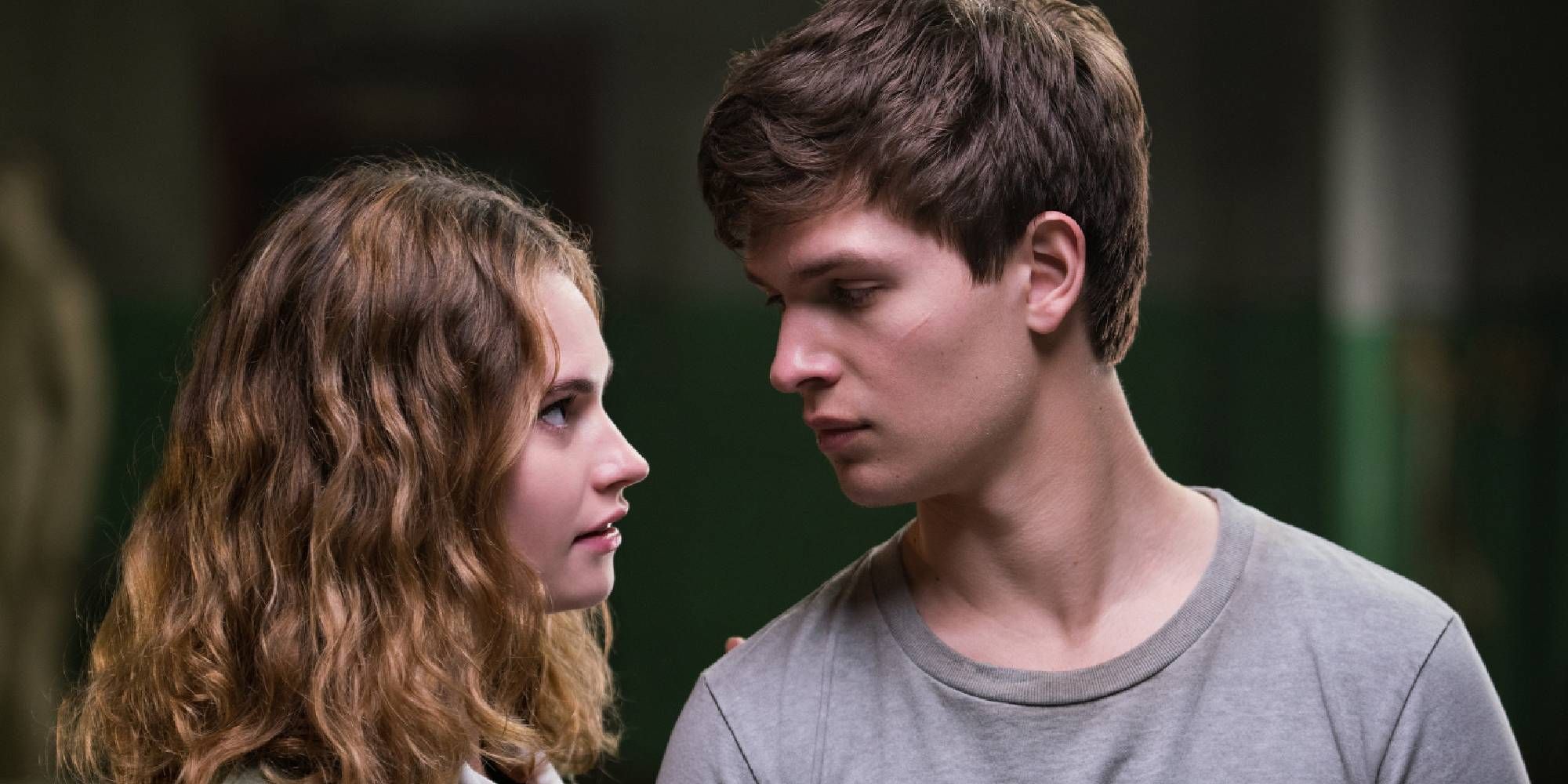 Lily James and Ansel Elgort as Debora and Miles "Baby," looking at each other in Baby Driver