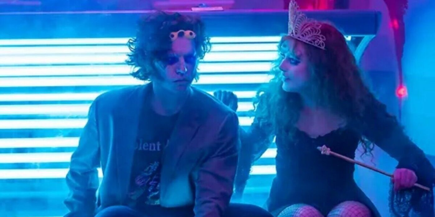 Cole Sprouse and Kathryn Newton sitting on the edge of a tanning bed in Lisa Frankenstein