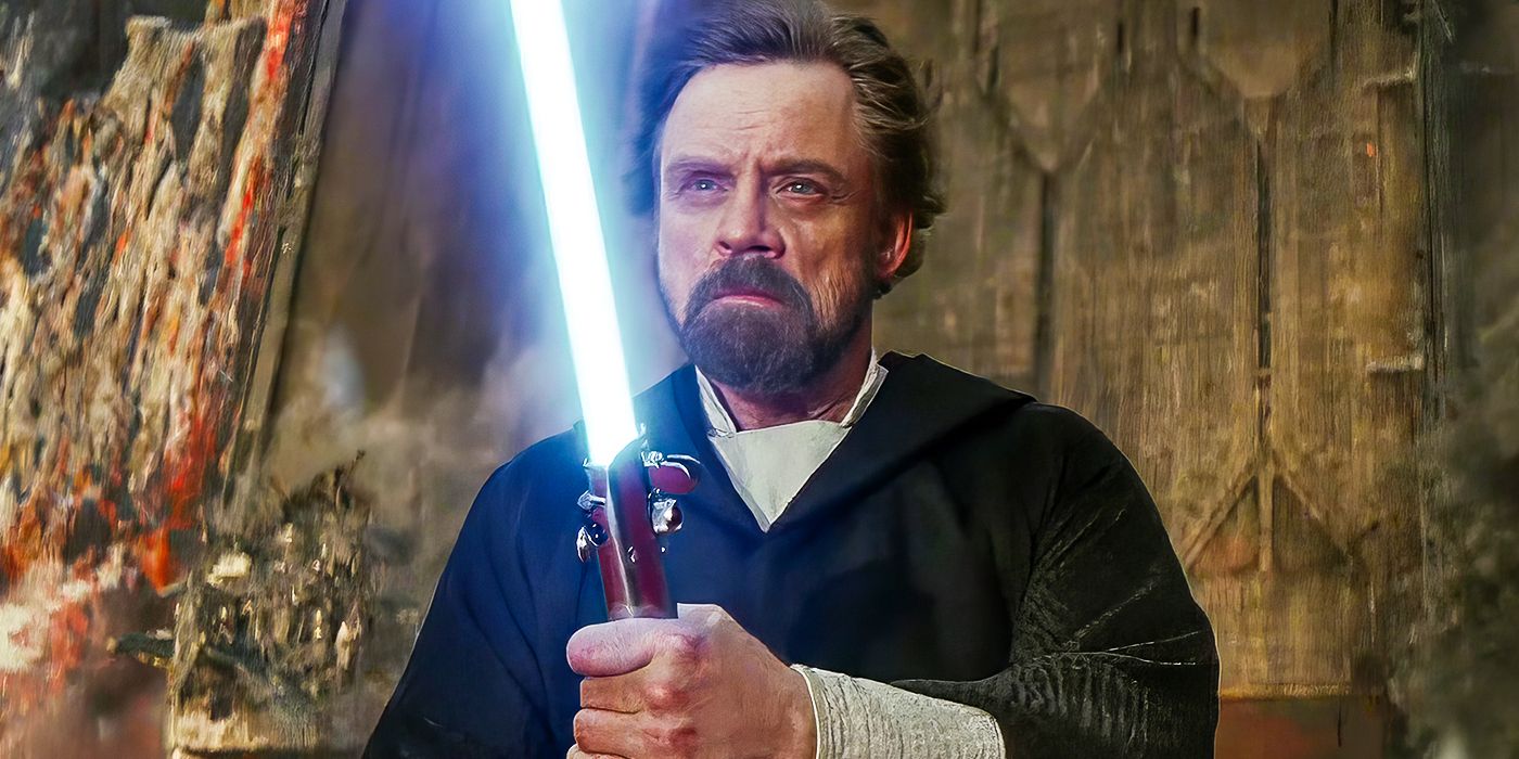 Luke Skywalker holding his blue lightsaber in Star Wars: The Last Jedi
