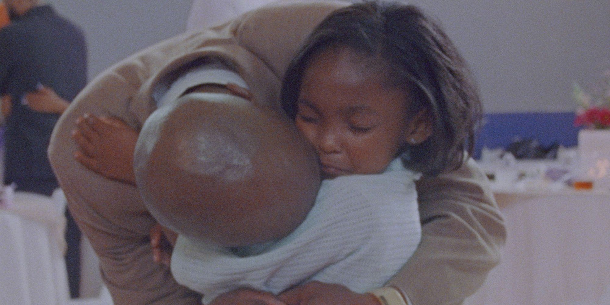A father and daughter embrace in prison in Daughters. 