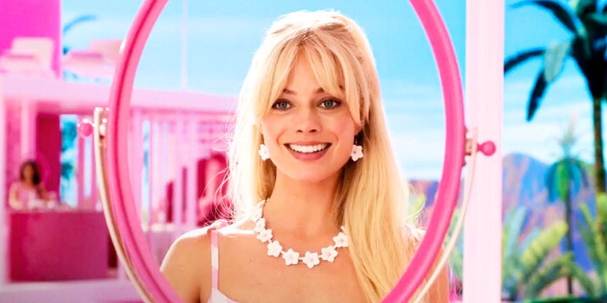 Barbie smiling in front of a glass-less mirror in Barbie (2023)