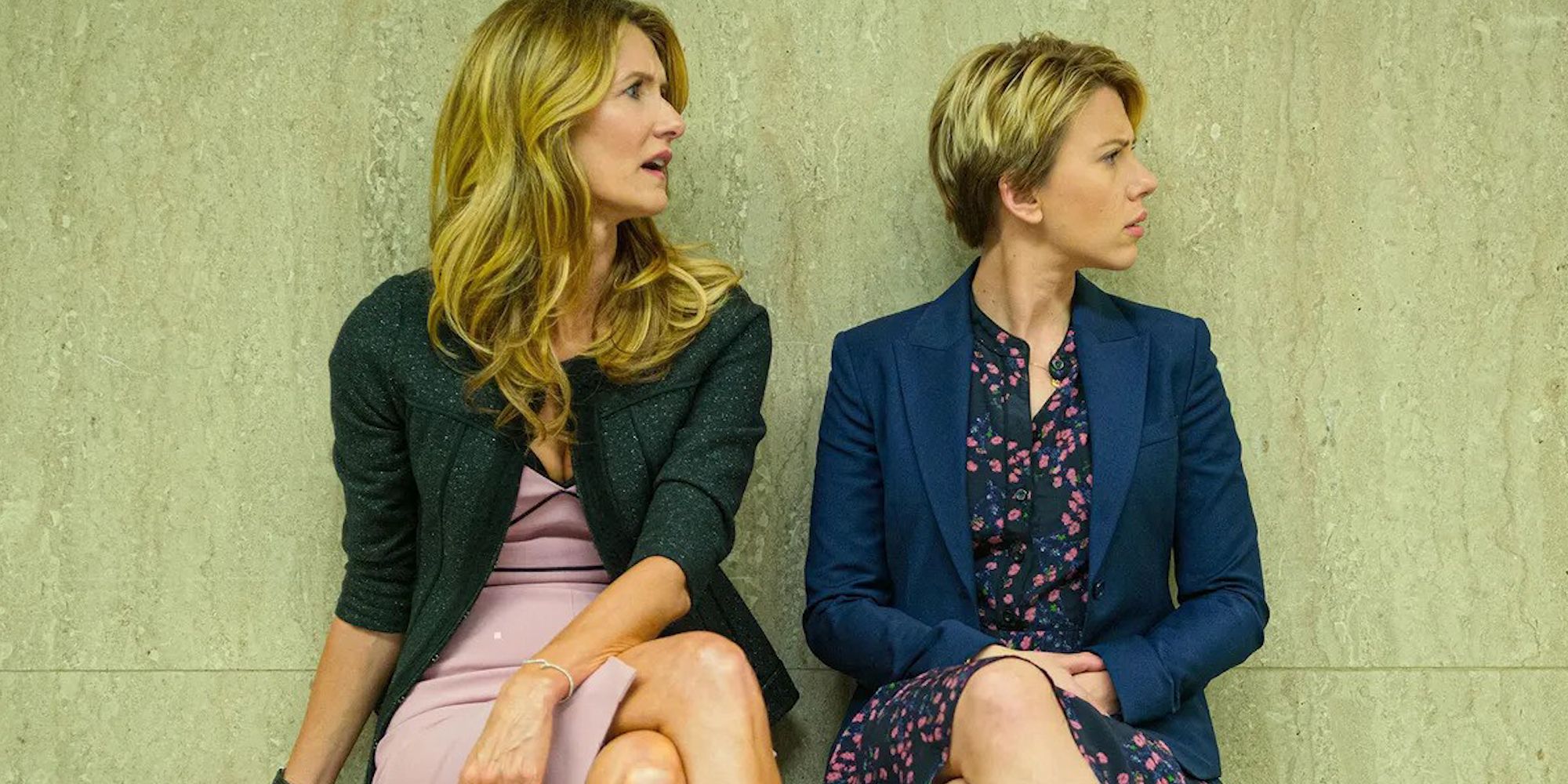 Laura Dern and Scarlett Johansson in Marriage Story looking to their left while sitting next to each other.